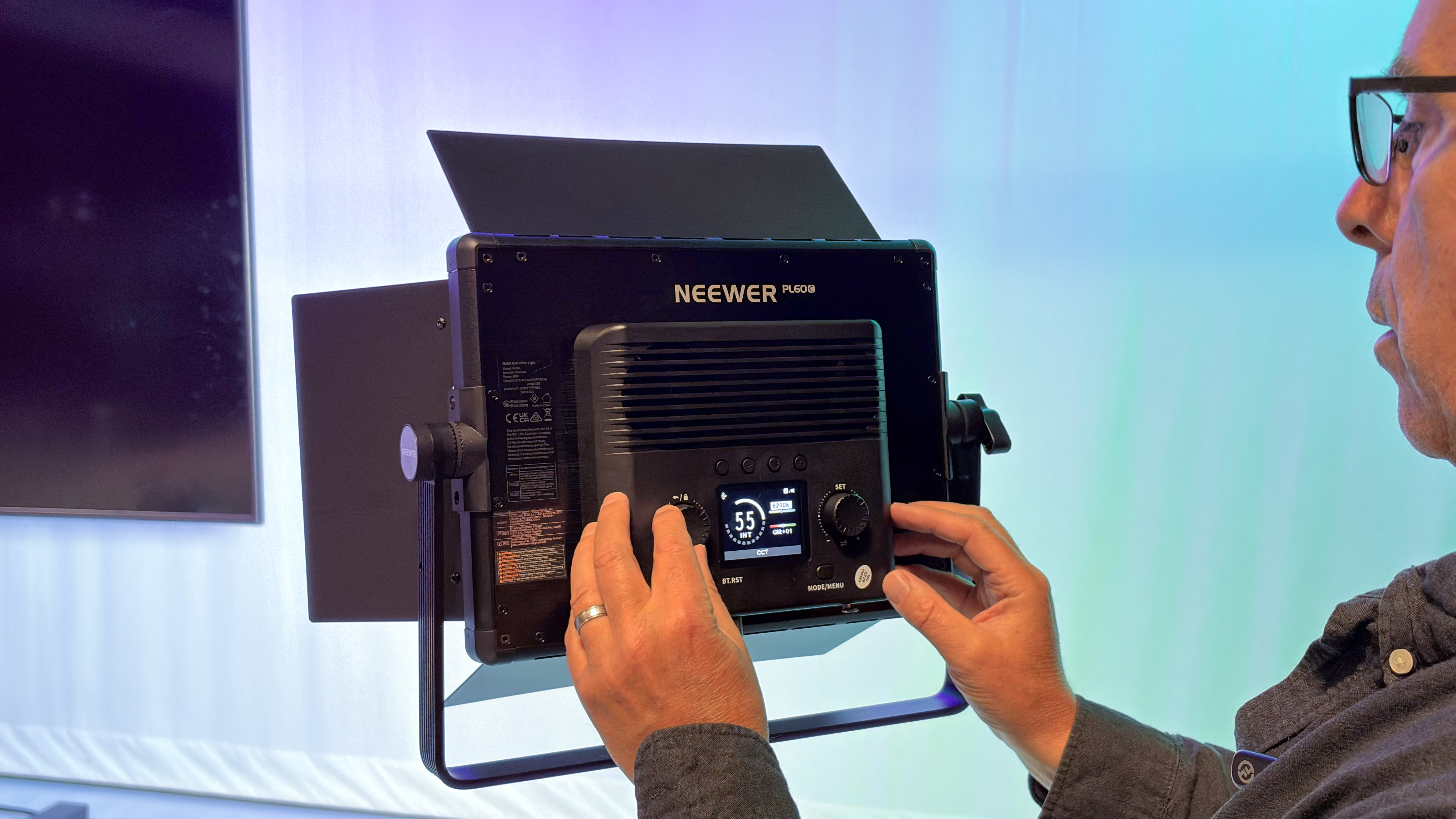 Shot of a the rear of the PL60C with a review&amp;rsquo;s hands adjusting plastic knobs