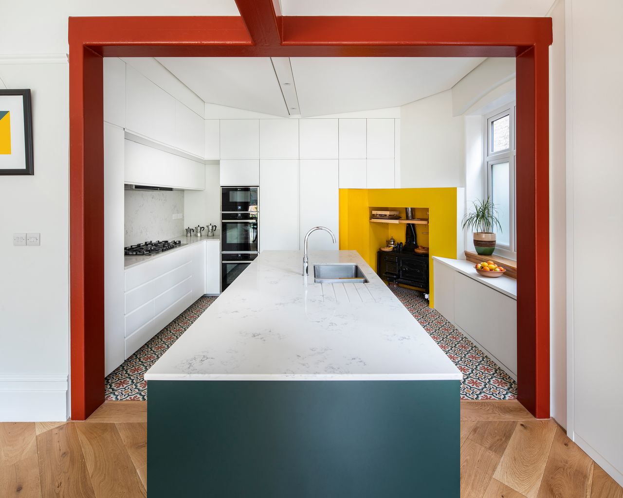 a modern kitchen with white walls and kitchen cabinets