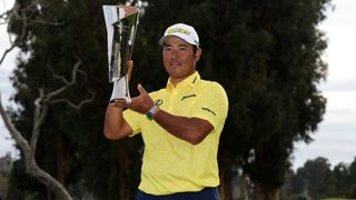 Hideki Matsuyama of Japan poses for a photo with the trophy after putting in to win on the 18th green during the final round of The Genesis Invitational at Riviera Country Club