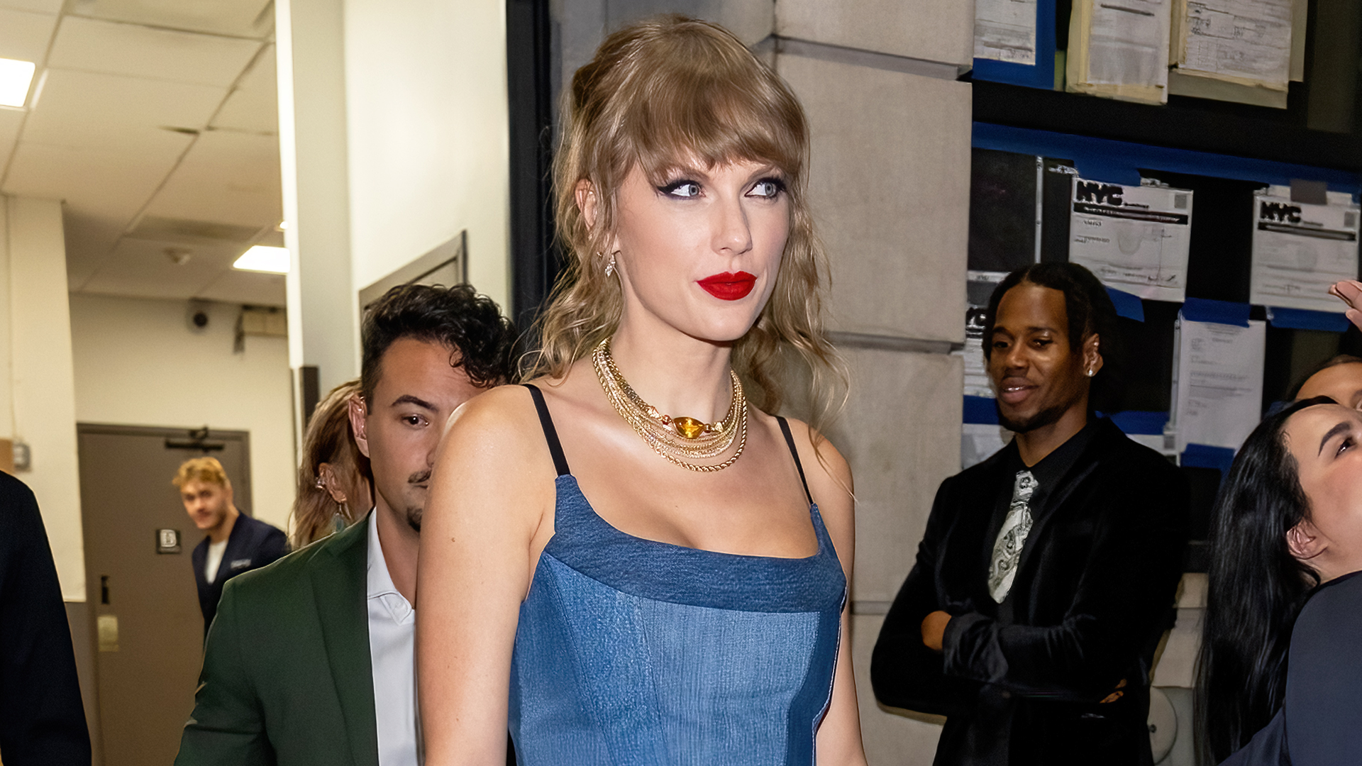 Taylor Swift delivers a surprise performance in a black denim EB Denim dress