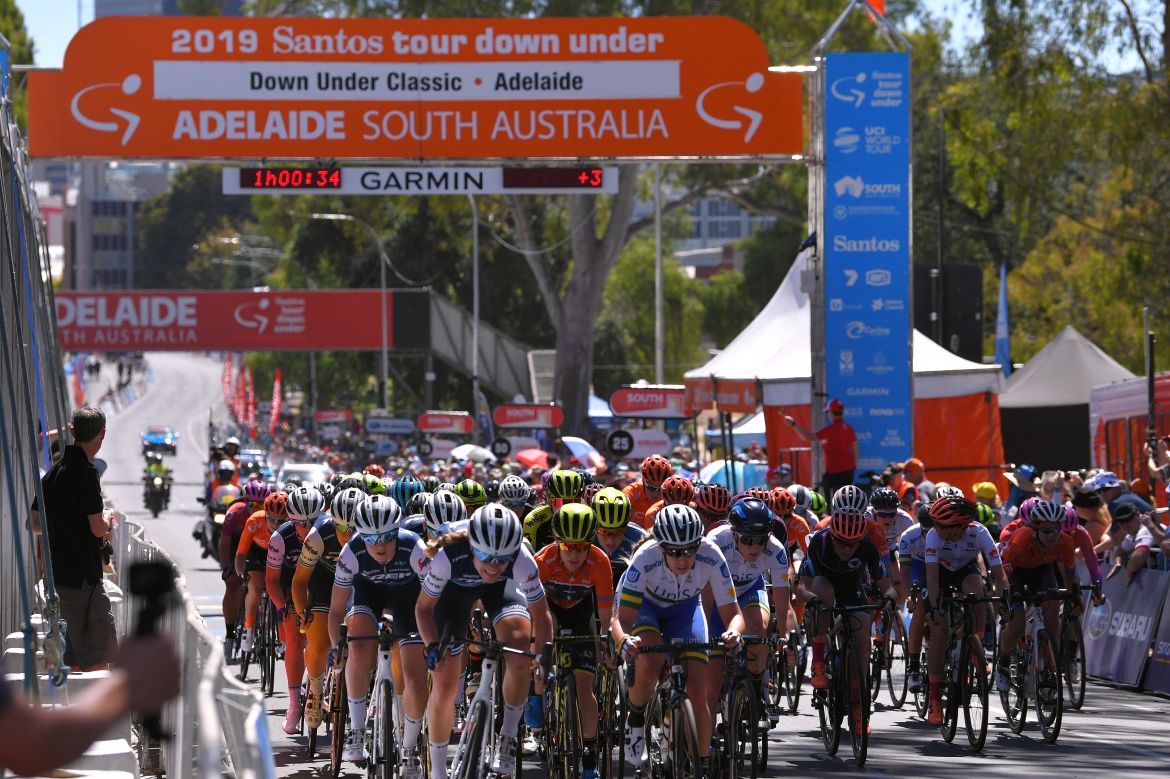 The peloton crosses the start-finish line.
