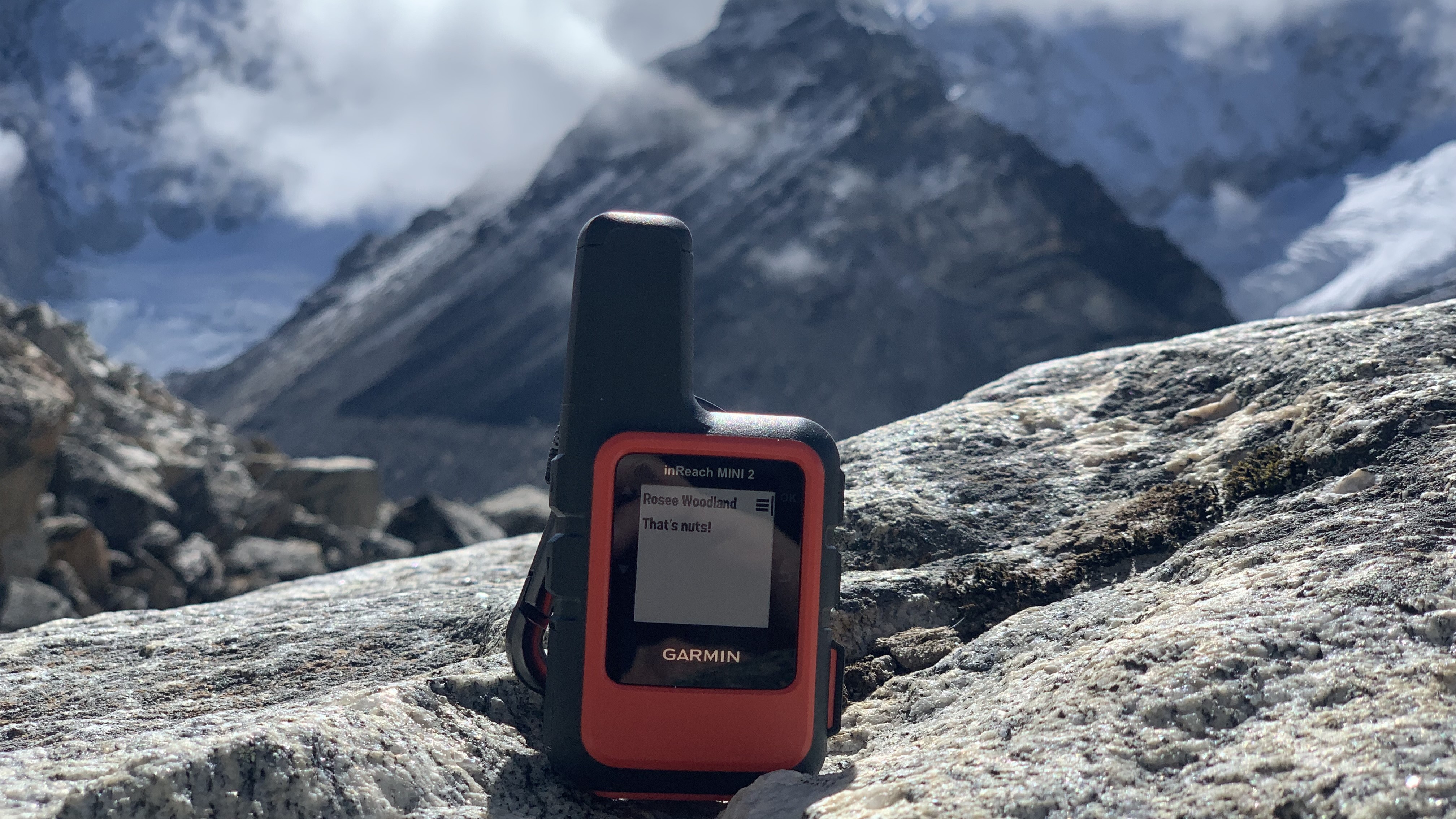 Garmin inReach Mini 2 on a rock in the Himalayas displaying a message