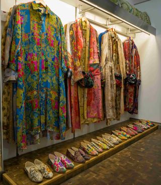 Hanging robes above row of slippers, all intricately patterned