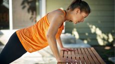 woman doing puch ups on bench