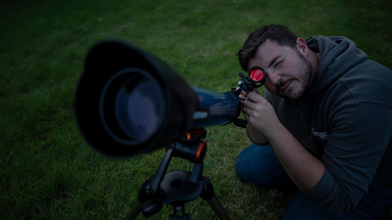 Man looking through a telescope