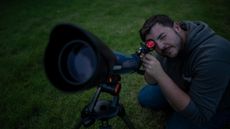 Man looking through a telescope