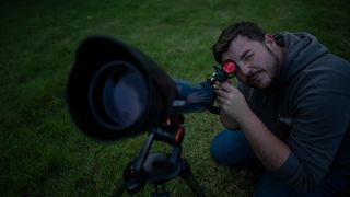 Man looking through a telescope