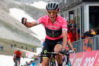 Pink jersey Britains rider of team MitcheltonScott Simon Yates celebrates as he crosses the finish line to win the 9th stage between Pesco Sannita and the Gran Sasso during the 101st Giro dItalia Tour of Italy cycling race on May 13 2018 Mitchelton rider Yates crossed just ahead of Frances Thibaut Pinto and Colombian Esteban Chaves on the finished line at 2135 metres altitude The race included a gruelling 265km final climb to Campo Imperatore where Benito Mussolini was imprisoned in 1943 Photo by Luk Benies AFP Photo credit should read LUK BENIESAFP via Getty Images