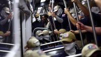 WASHINGTON, DC - JULY 04: A passenger (C) looks on as members of the white supremacist group Patriot Front ride the Washington Metro on July 04, 2026 in Washington, DC. Numerous events, activities, and fireworks are planned in celebration of America's 250th Anniversary. (Photo by Finn Gomez/Getty Images)