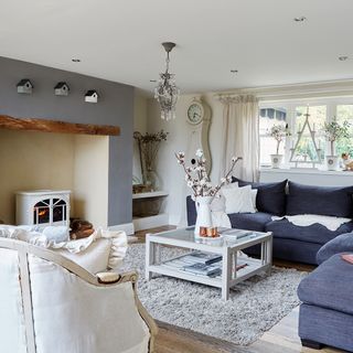living room with central coffee table, sofa set and fireplace