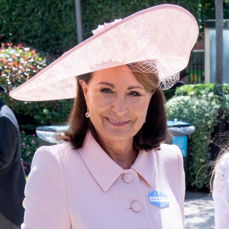 Carole Middleton wears a baby pink dress and matching hat, while carrying a top handle bag in the same shade to attend Royal Ascot 2026