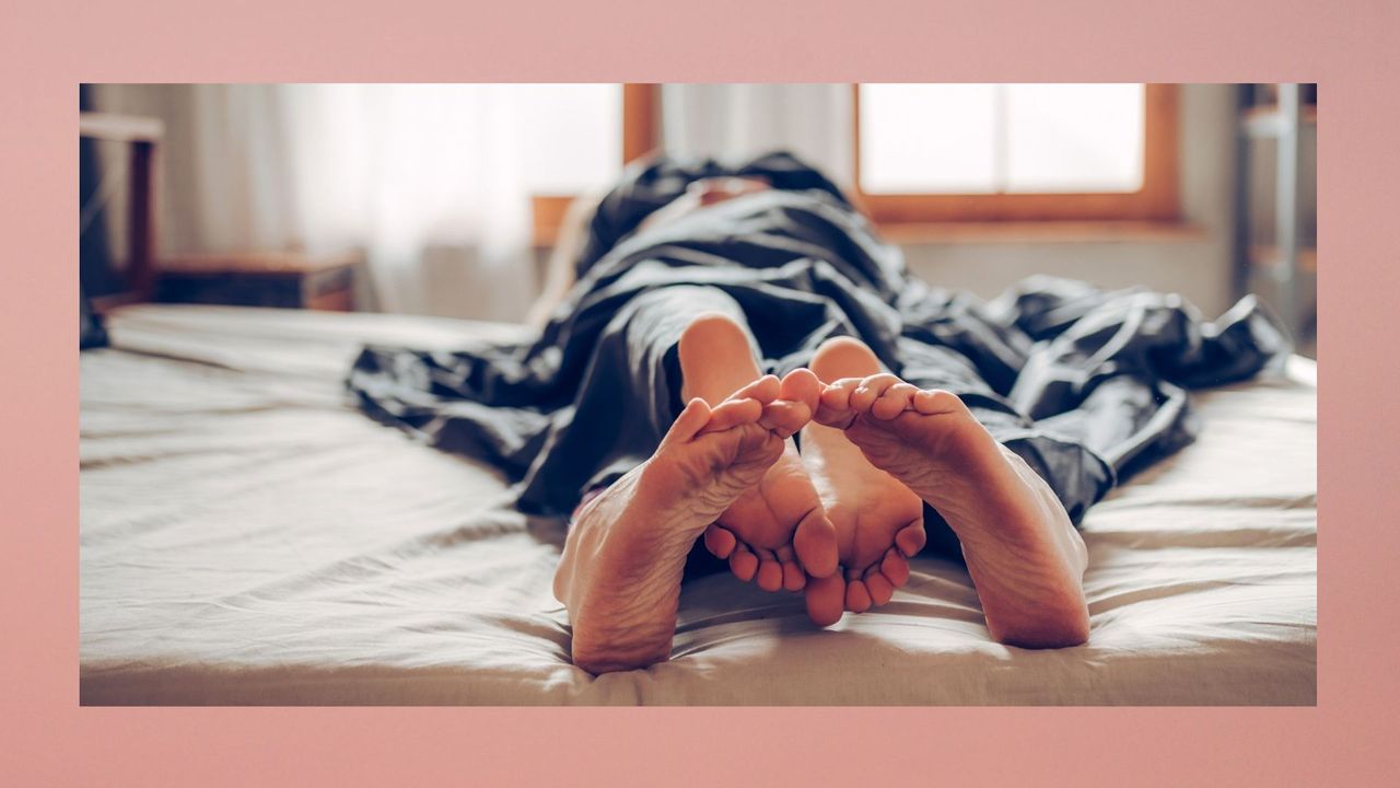 couple on top of each other in bed with their feet at the end of the bed