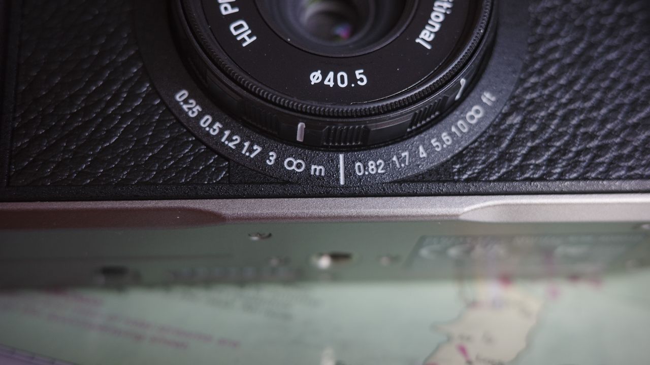 Close up of the Pentax 17 compact film camera's focus distance indicator
