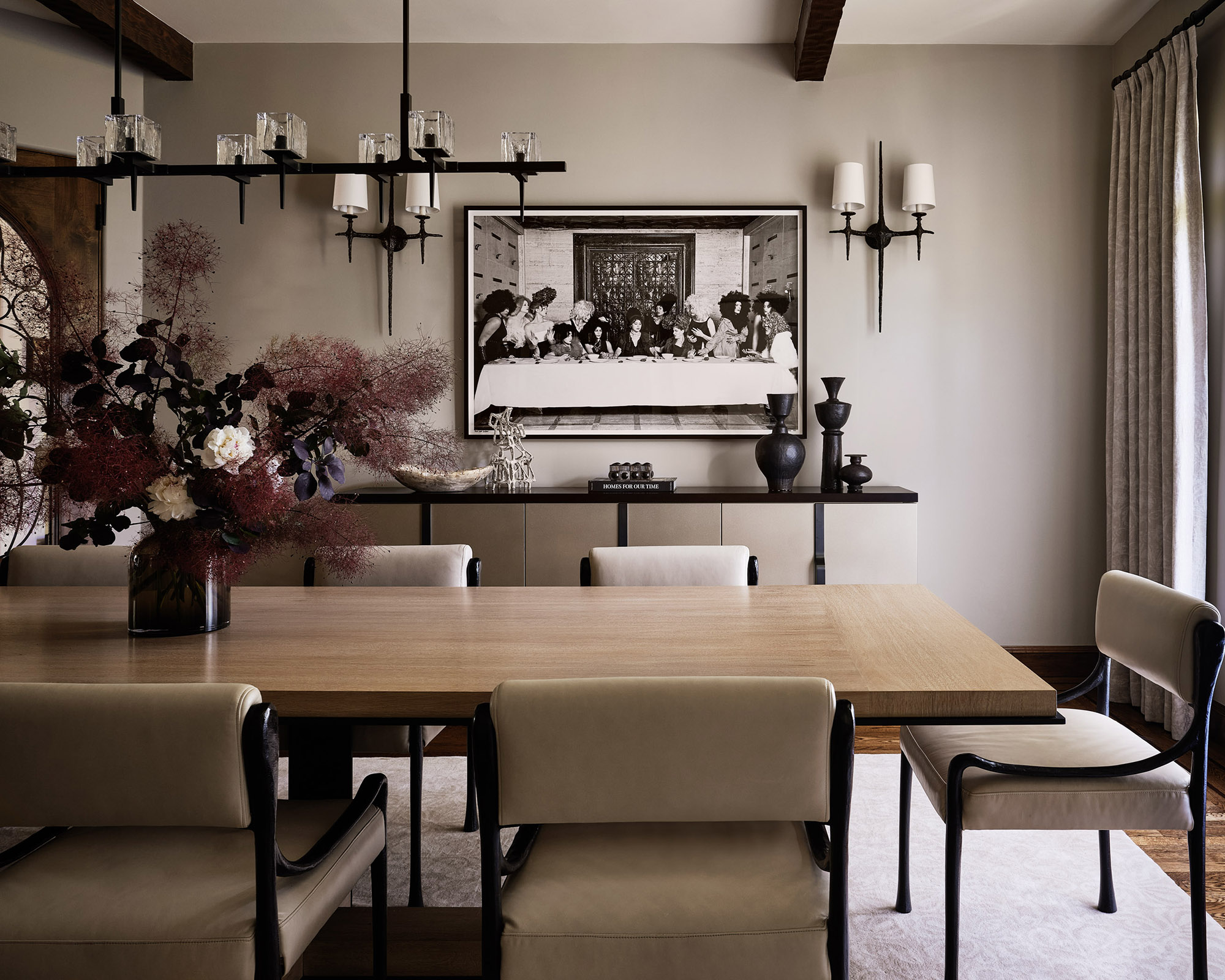 dining room with large wood table and modern light fitting hanging over the top