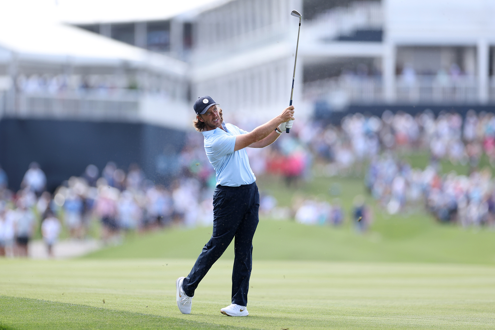 Tommy Fleetwood in his trademark finish position with an iron after his small circle action