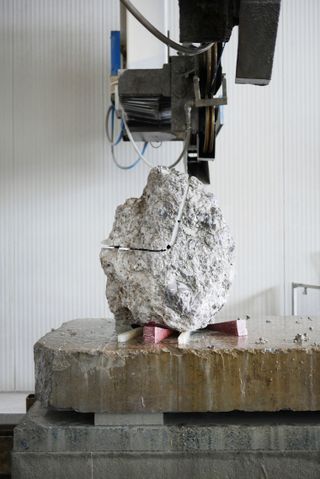 A large boulder being cut in the middle to create a seat