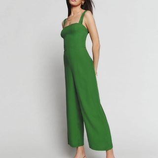 model wearing Reformation Green Jumpsuit