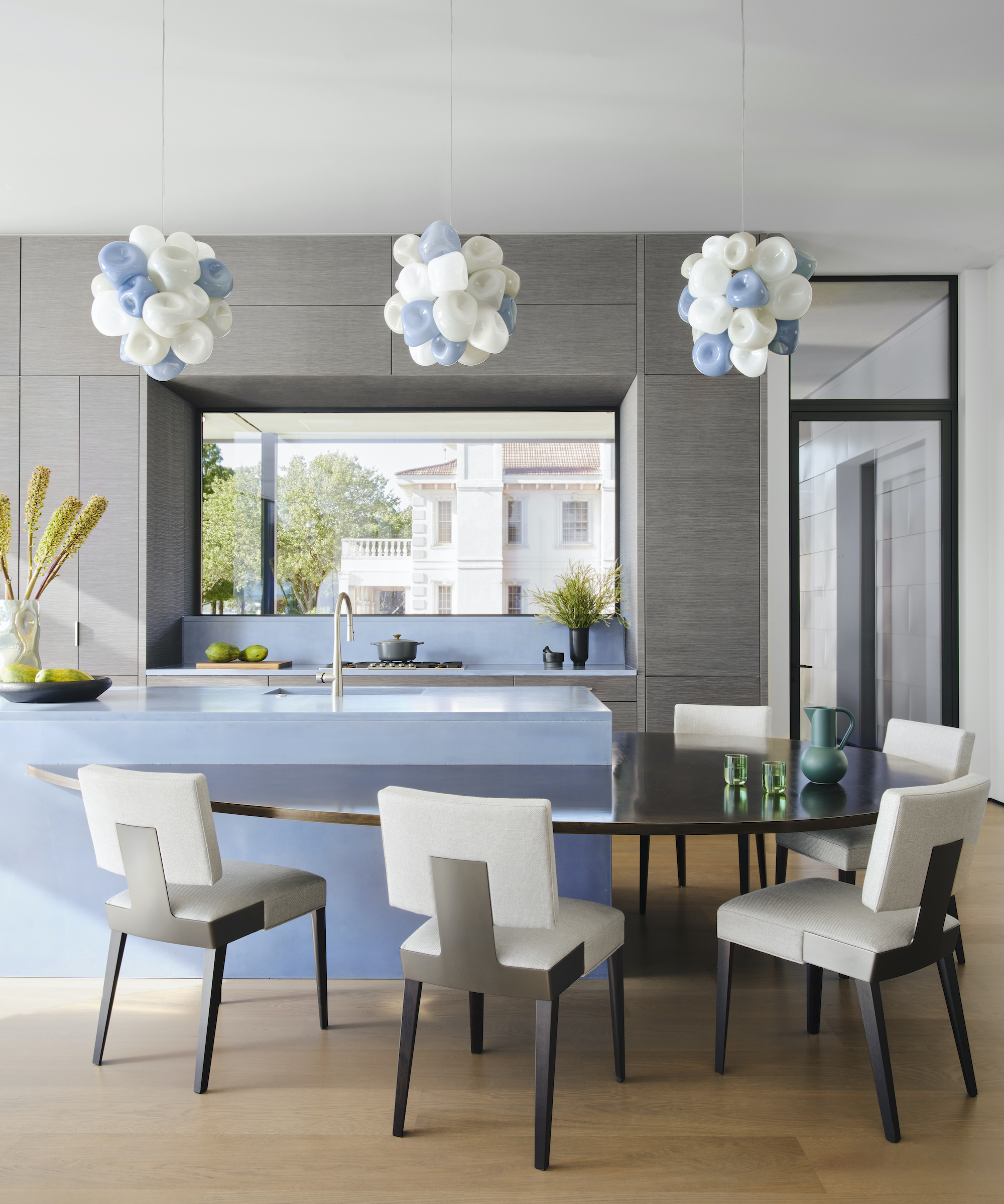 blue kitchen island with drop level table and dining chairs