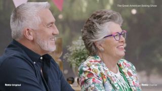 Paul and Prue smiling in The Great American Baking Show