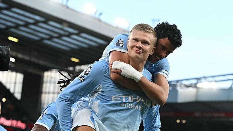 Erling Haaland celebrates with Manchester City's Portuguese midfielder Matheus Nunes (R) after scoring the opening goal during the Premier League match between Liverpool and Manchester City.