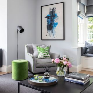 grey living room with armchair, coffee table and abstract art