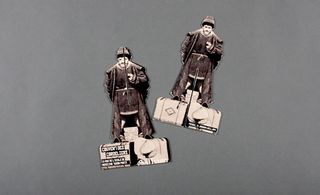 Two cardboard models of a Russian émigré with his suitcases invitation