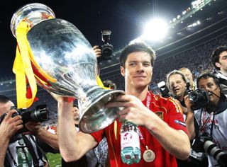 Xabi Alonso celebrates with the European Championship trophy after Spain's win at Euro 2008.