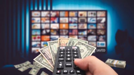 Remote control with money and television with streaming services