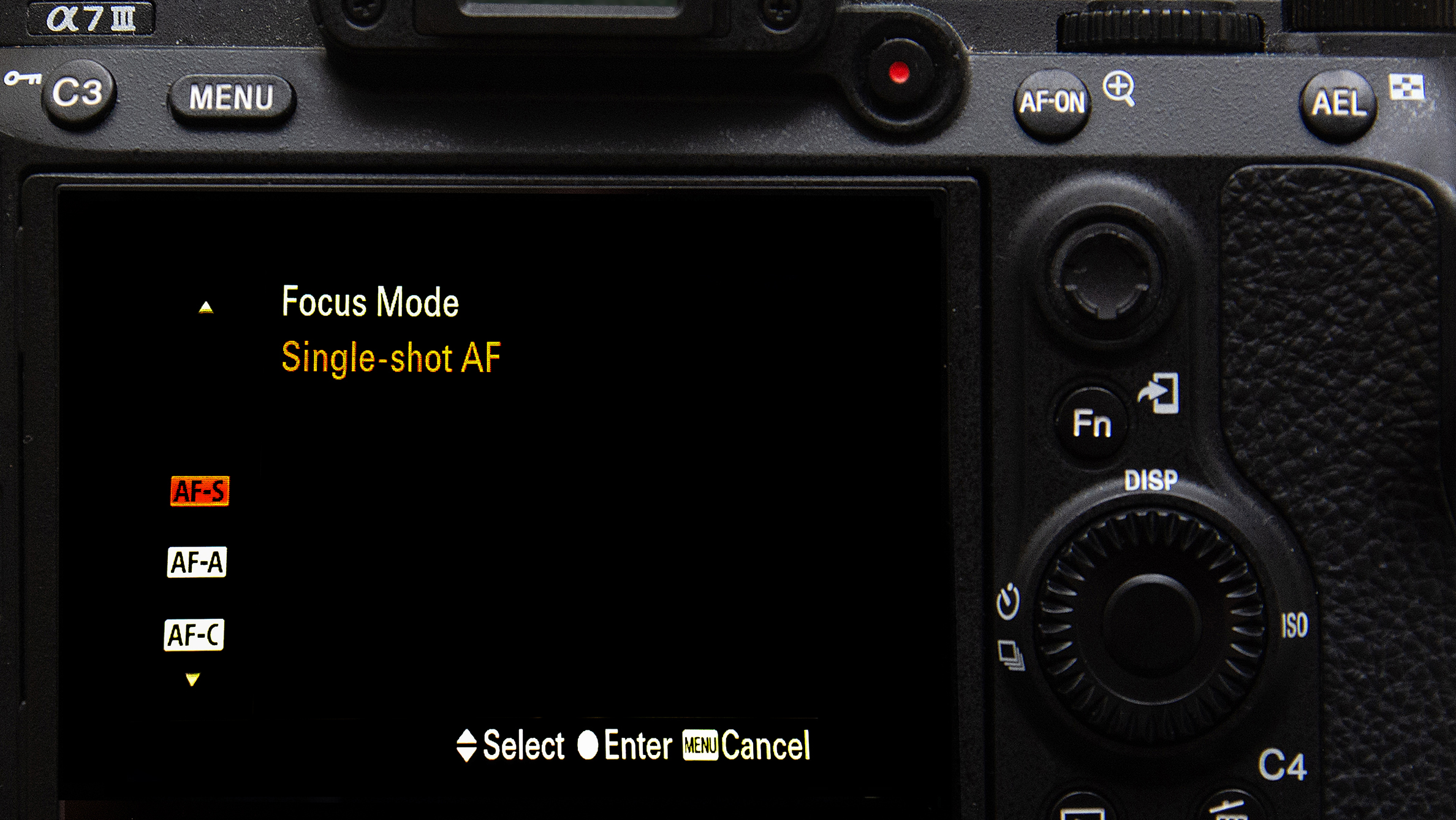 Close-up of a Sony Alpha 7 III camera screen displaying the focus mode settings, highlighting "Single-shot AF"