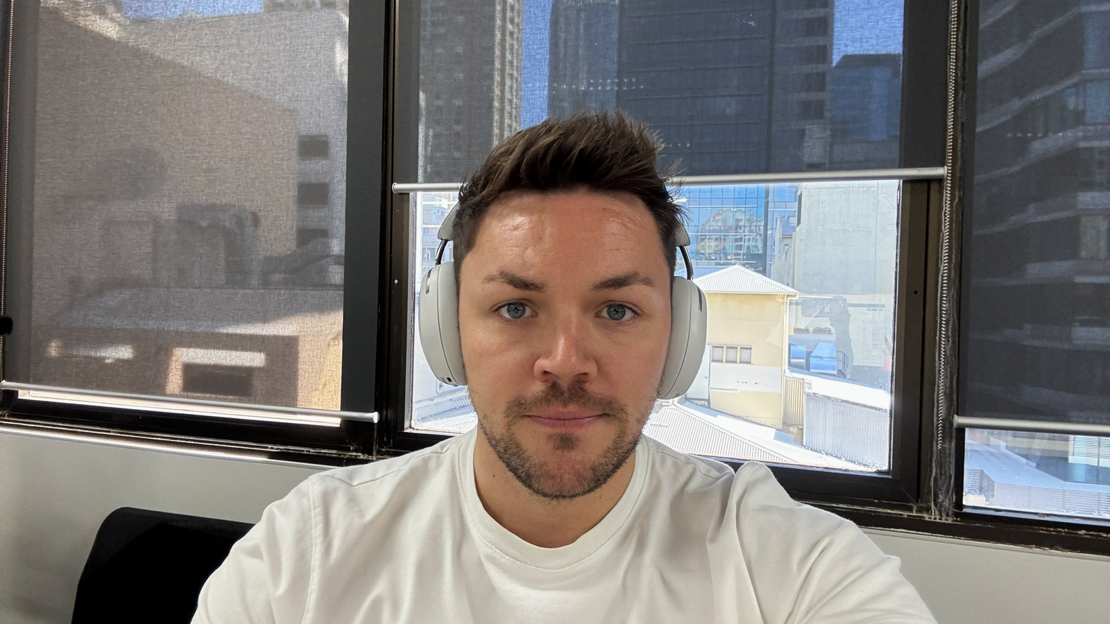 TechRadar writer Max Langridge with a pair of white Sonos Ace headphones.