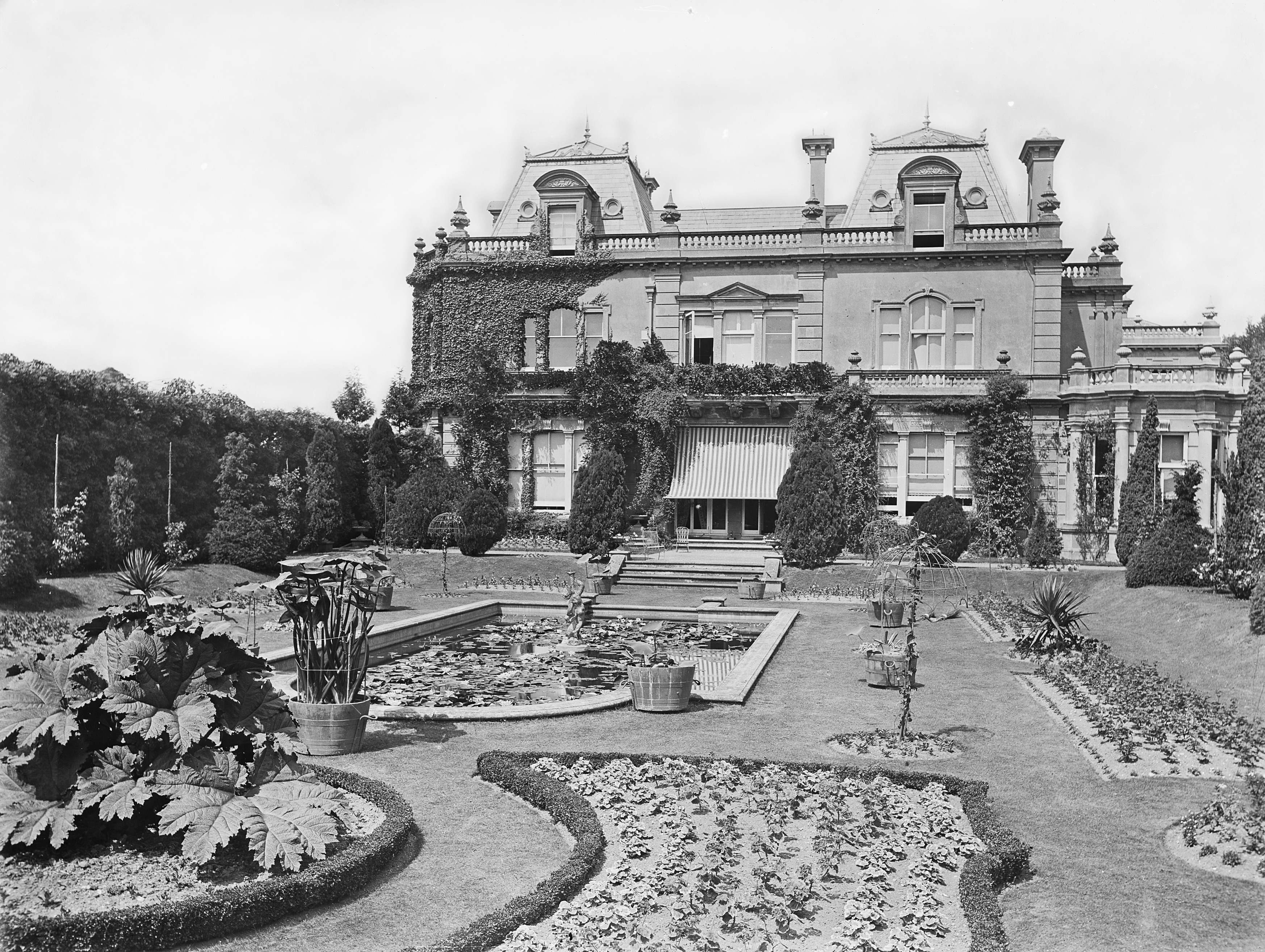 A manor house with large, Victorian greenhouses and a rare collection of plants