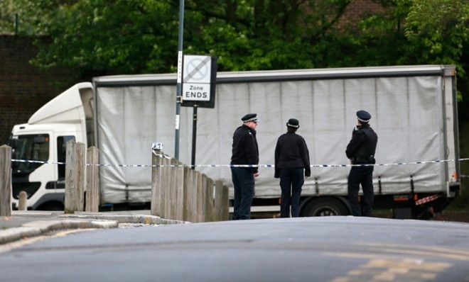 Officers stand guard near a crime scene where a man was brutally murdered in Woolwich, southeast London May 22.