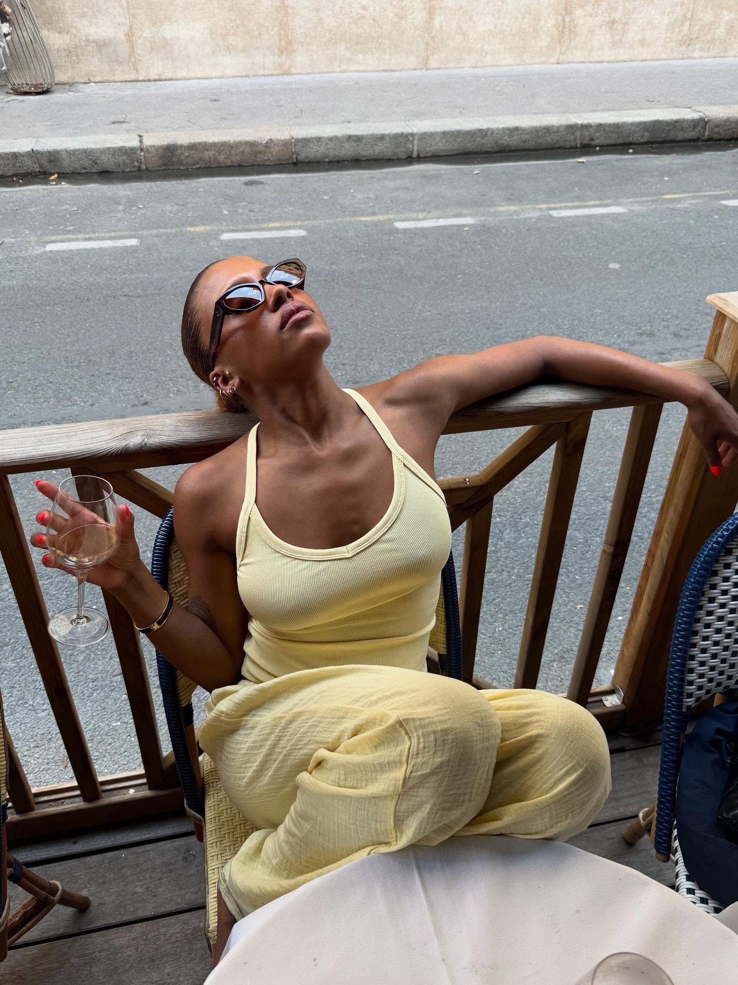 Influencer MV Tiangue wearing a butter yellow racerback top and yellow linen trousers.
