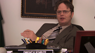 Rainn Wilson as Dwight Schrute talking while at his desk in The Office, Season 7, Episode 10