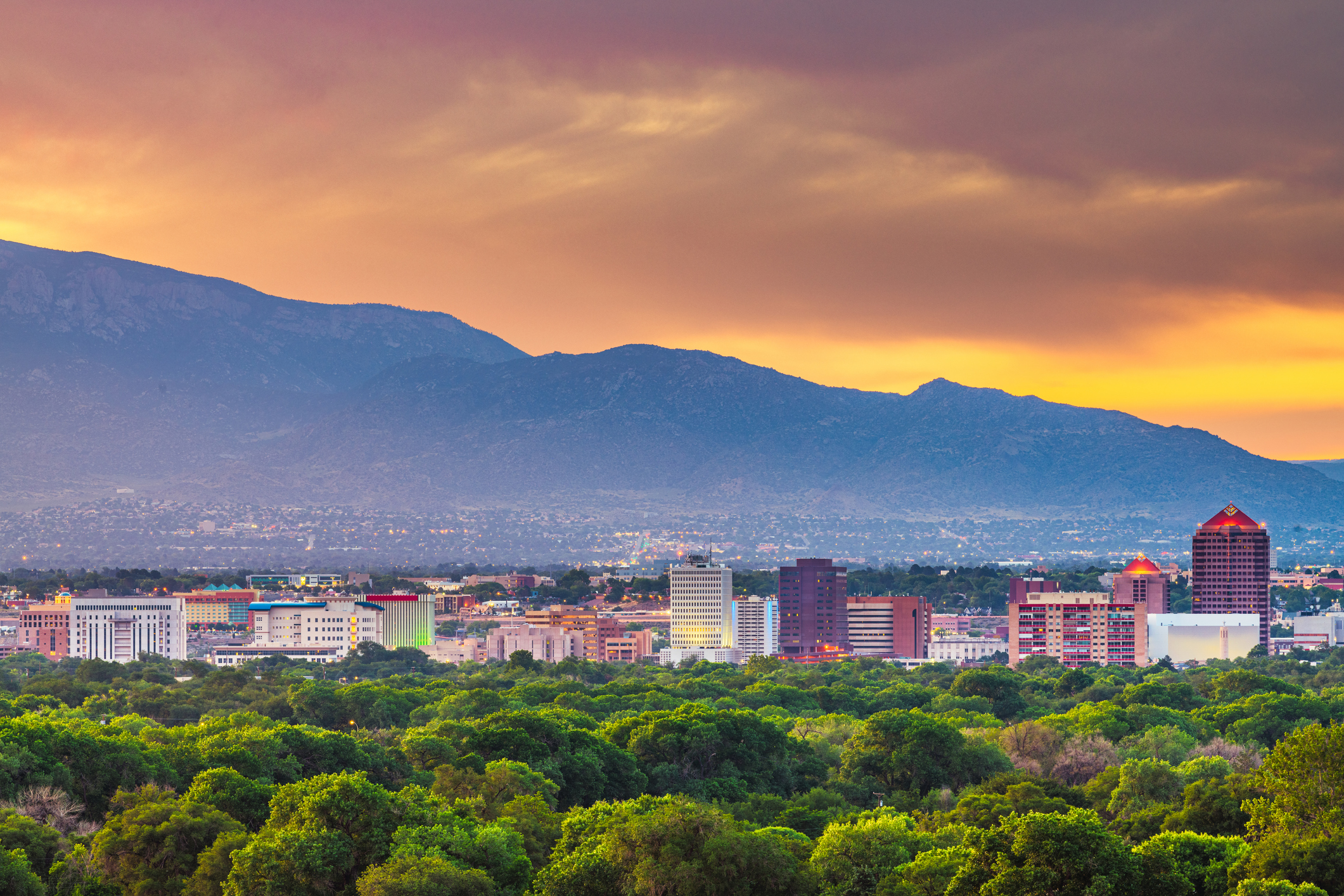 Downtown Albuquerque, New Mexico at twilight with mountains in the background