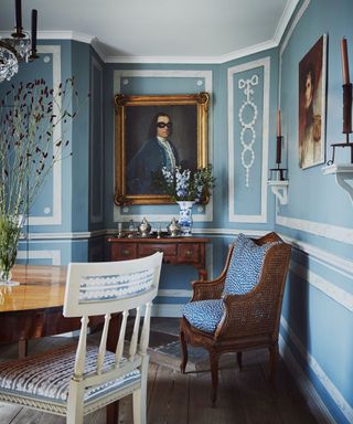 traditional dining room with blue and white panelled walls and wooden furniture