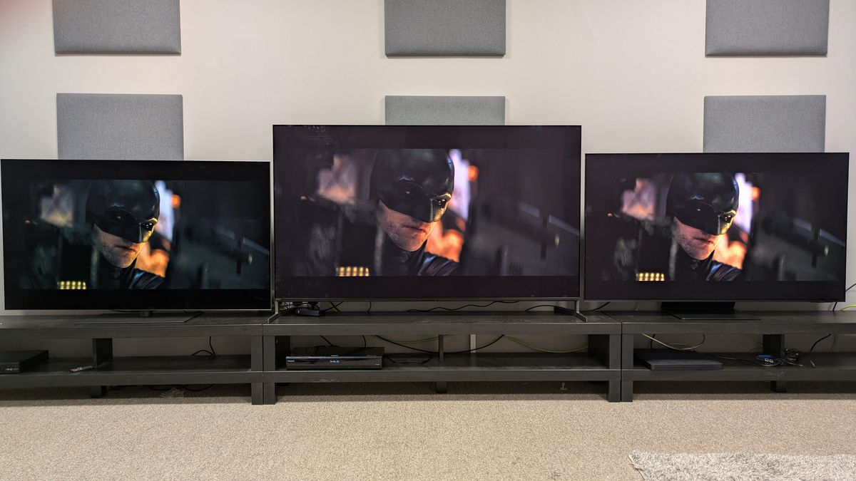 LG G5 (left) Sony Bravia 8 II (middle) and Samsung S95F (left) with face of Batman on screen from The Batman with Sony's brighter tone mapping setting