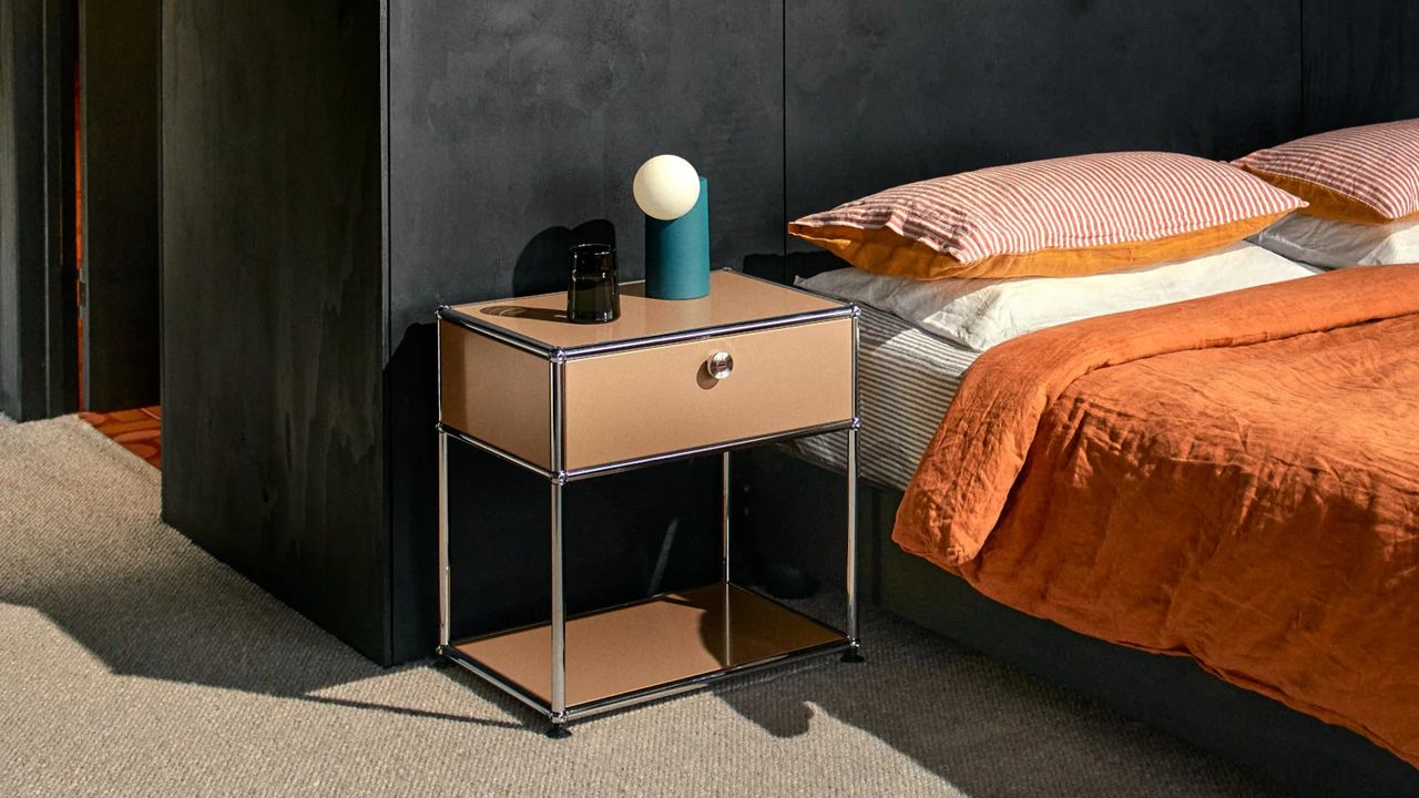 beige steel-frame nightstand next to bed