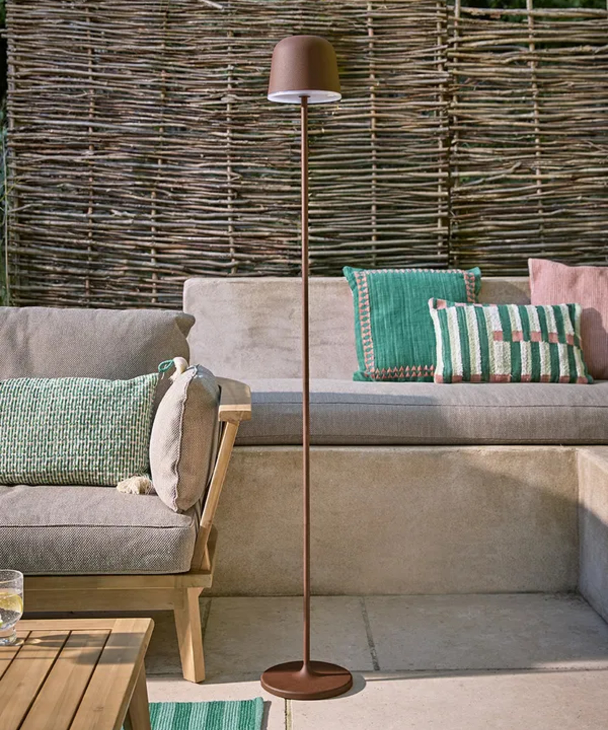 Cox &amp;amp; Cox's Nocturne Rechargeable LED Floor Lamp in Rust in a garden