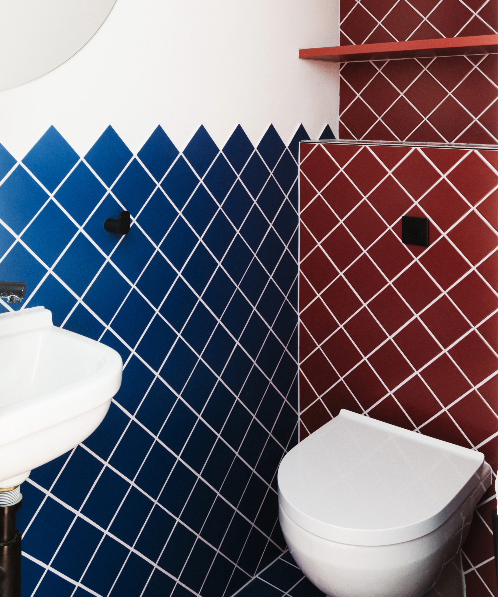 Toilet with red and blue diamond tiles