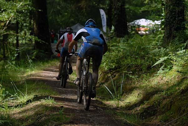 Two riders on some singletrack.