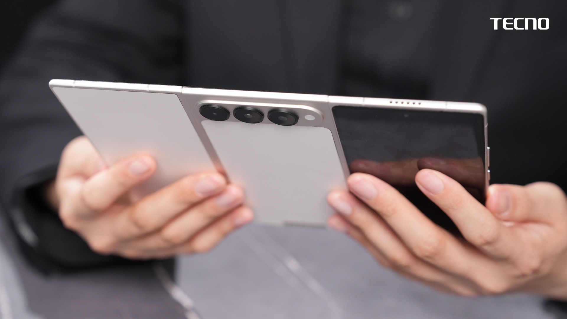 The TECNO G Fold concept from behind, showing off its three panels and triple camera array.