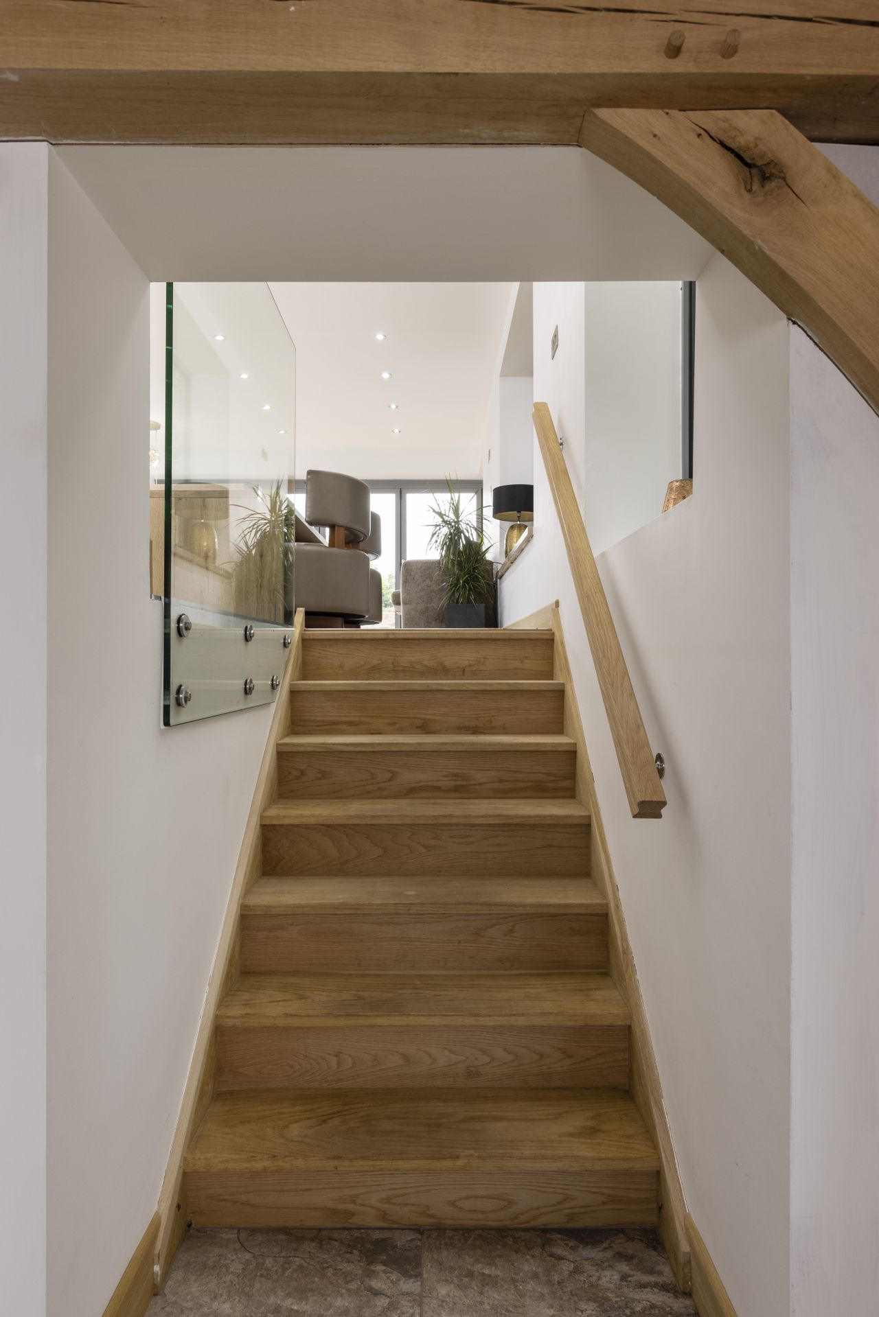 staircase in open plan living space with white walls