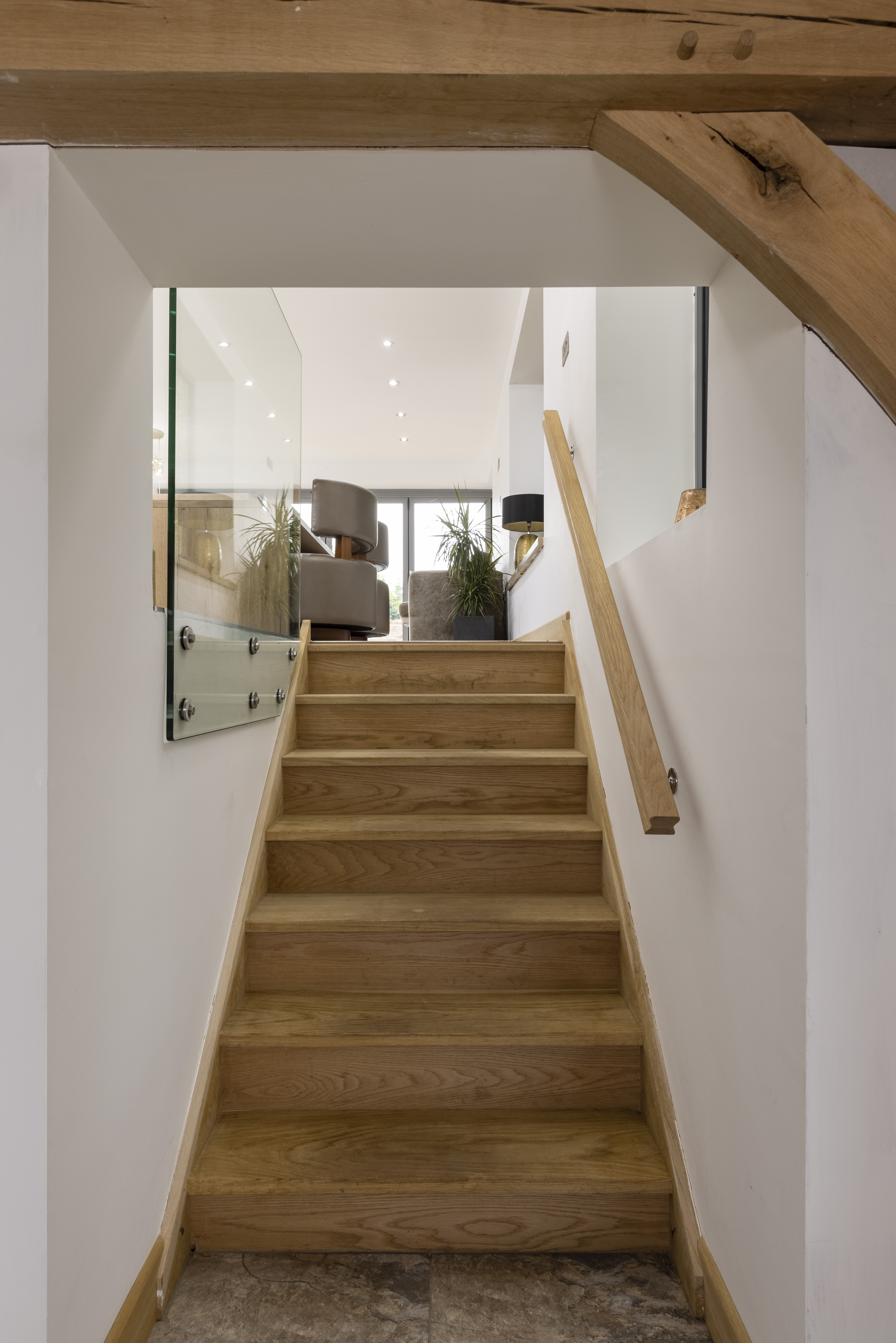 staircase in open plan living space with white walls
