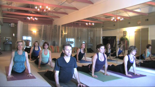 In the YOGAmazing app, instructor Chaz Rough (shown here in the front row, wearing a black shirt) offers instructions that are clear and not intimidating for first-timers.