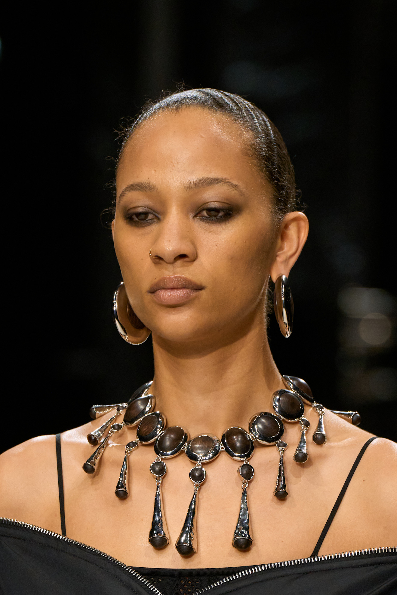 a givenchy model wears oversize jewelry on the fall/2026 runway