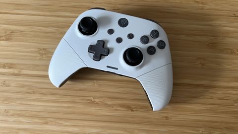 EasySMX X10 controller in white on a wooden table