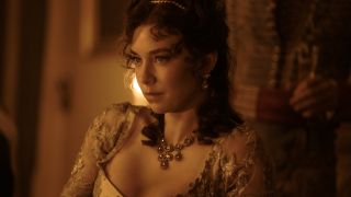 Vanessa Kirby sitting bathed in amber light in Napoleon.