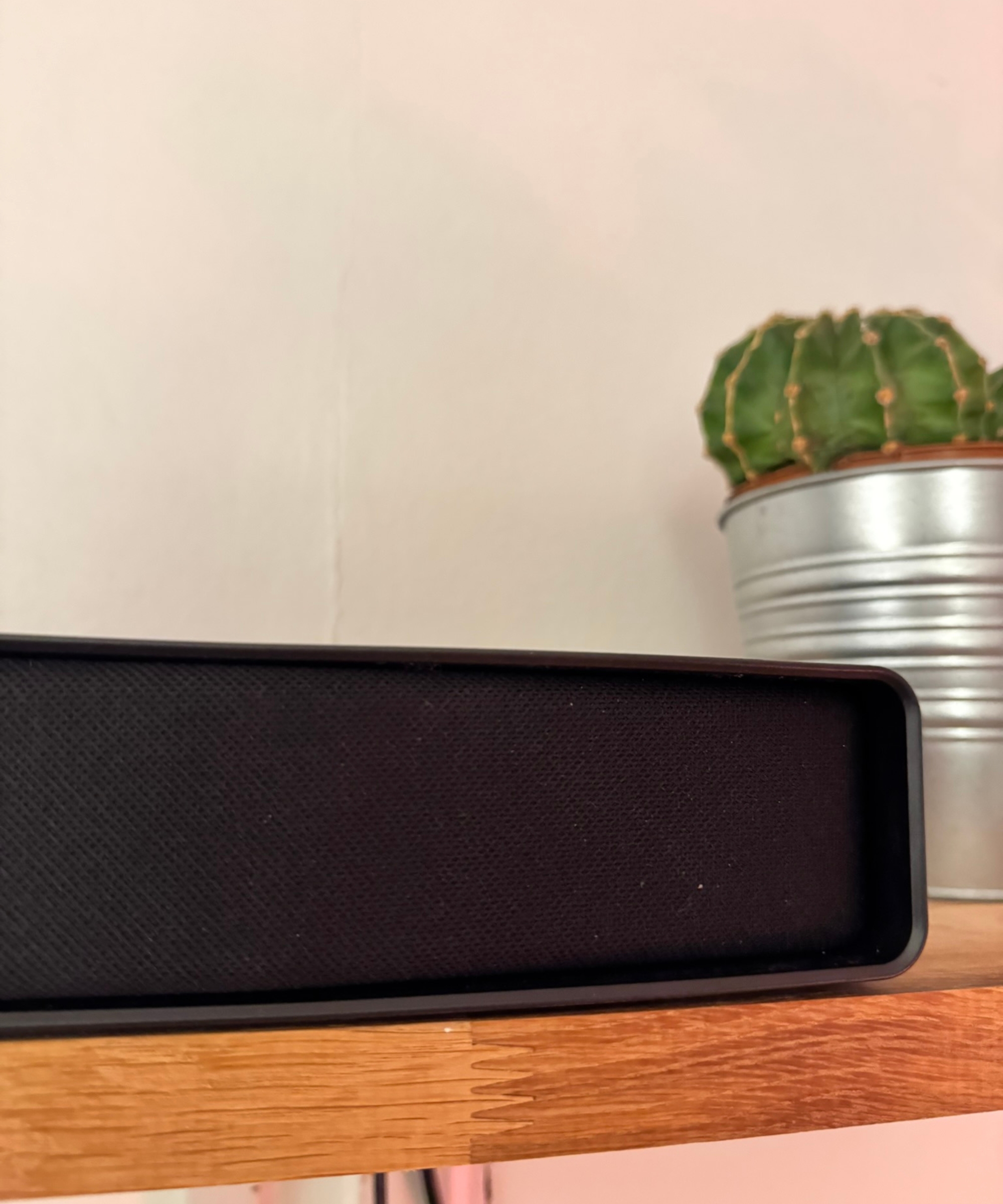 Hisense AX5140Q soundbar on wooden shelf, pictured in front of potted cactus.