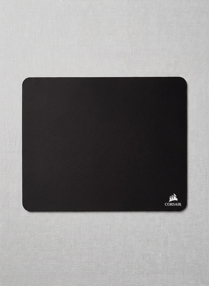 A Corsair MM100 mouse pad on a grey background A Corsair MM100 mouse pad on a grey background